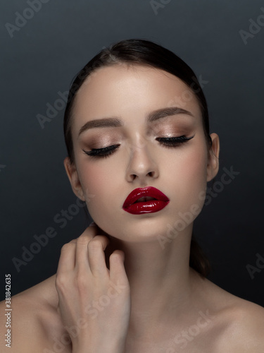 Portrait of young beautiful woman with red lips