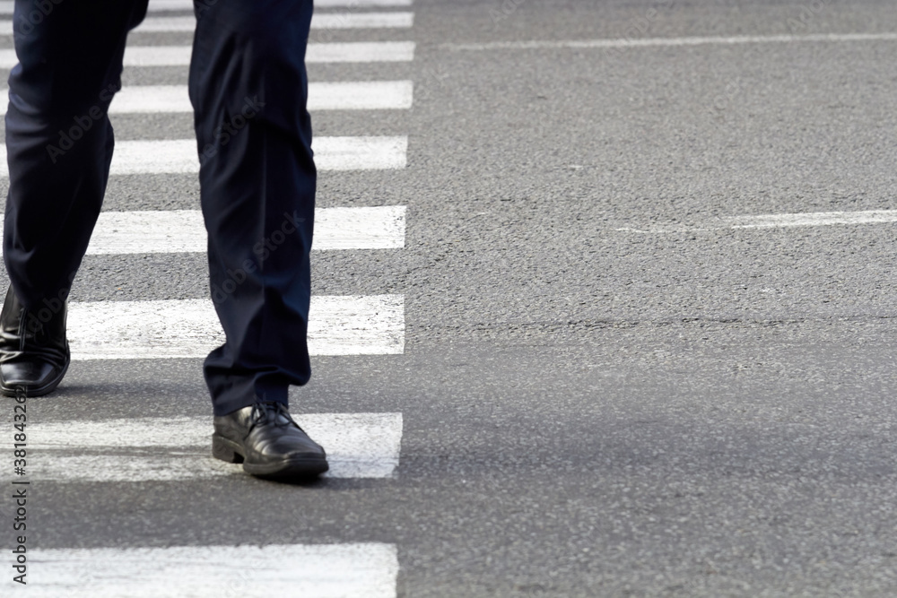 People on a crosswalk and asphalt street, urban environment People on a crosswalk and asphalt street, urban environment