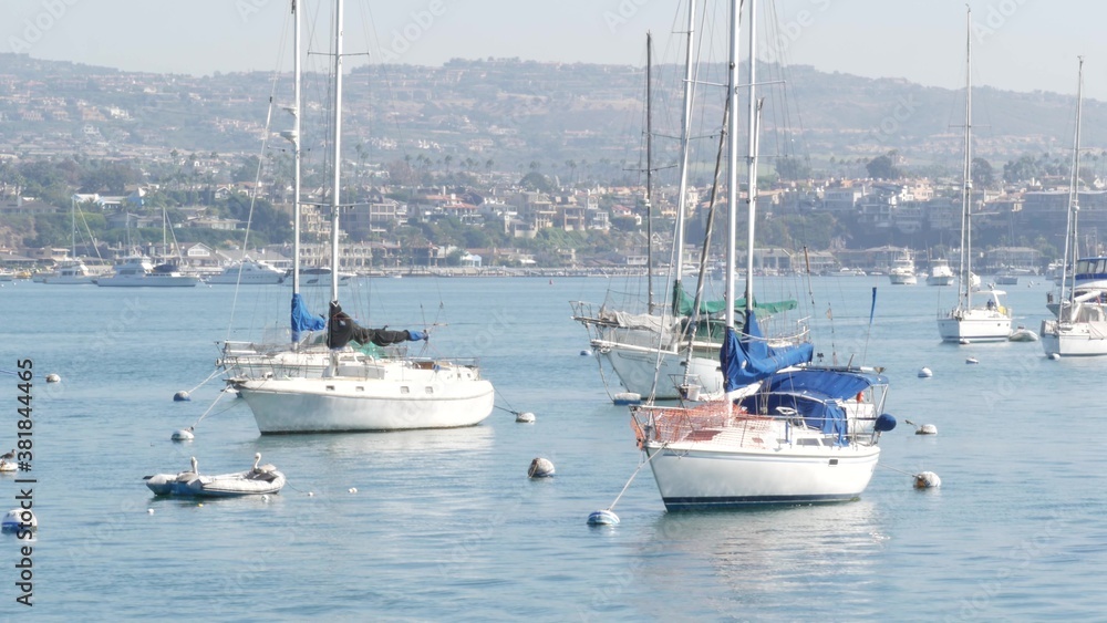 Newport beach harbor, weekend marina resort with yachts and sailboats, Pacific Coast, California, USA. Waterfront luxury suburb real estate in Orange County. Expensive beachfront holiday destination