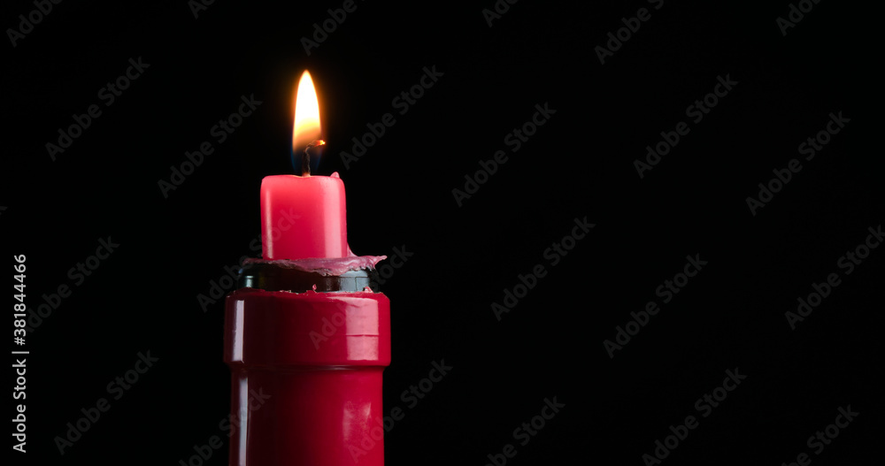 red candle in a red wine bottle red candle in a red wine bottle
