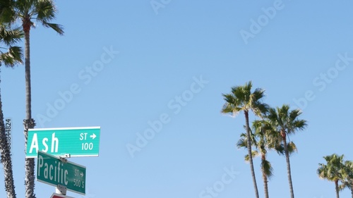 Pacific street road sign on crossroad, route 101 tourist destination, California, USA. Lettering on intersection signpost, symbol of summertime travel and vacations.Signboard in city near Los Angeles © Dogora Sun