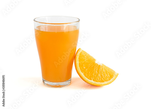 Glass of fresh orange juice with fresh orange slices cut in half on white background with copy space, banner