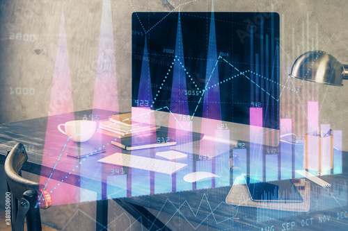 Financial chart drawing and table with computer on background. Multi exposure. Concept of international markets.