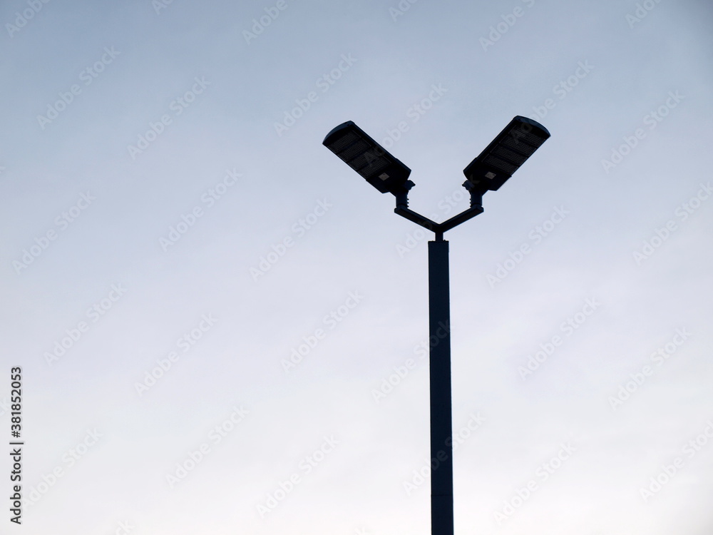 LED lamp silhouette. Energy saving street lamp with dull blue background with copy space. Selective focus LED lamp silhouette. Energy saving street lamp with dull blue background with copy space. Selective focus