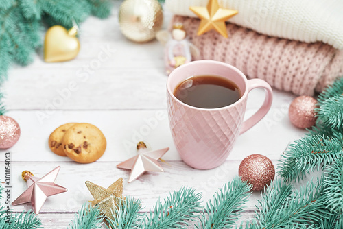 Christmas table setting. Cup of coffee or tea on background of Christmas tree. Christmastime celebration. Winter Holidays. Xmas mock up. Greeting card template.