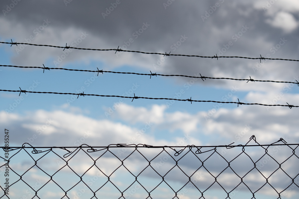 Backlight of a fence with barbed wire that symbolizes private property, immigration, and many other current issues that surround us every day.
Clouds can be seen in the background with a nice blur Backlight of a fence with barbed wire that symbolizes private property, immigration, and many other current issues that surround us every day.
Clouds can be seen in the background with a nice blur