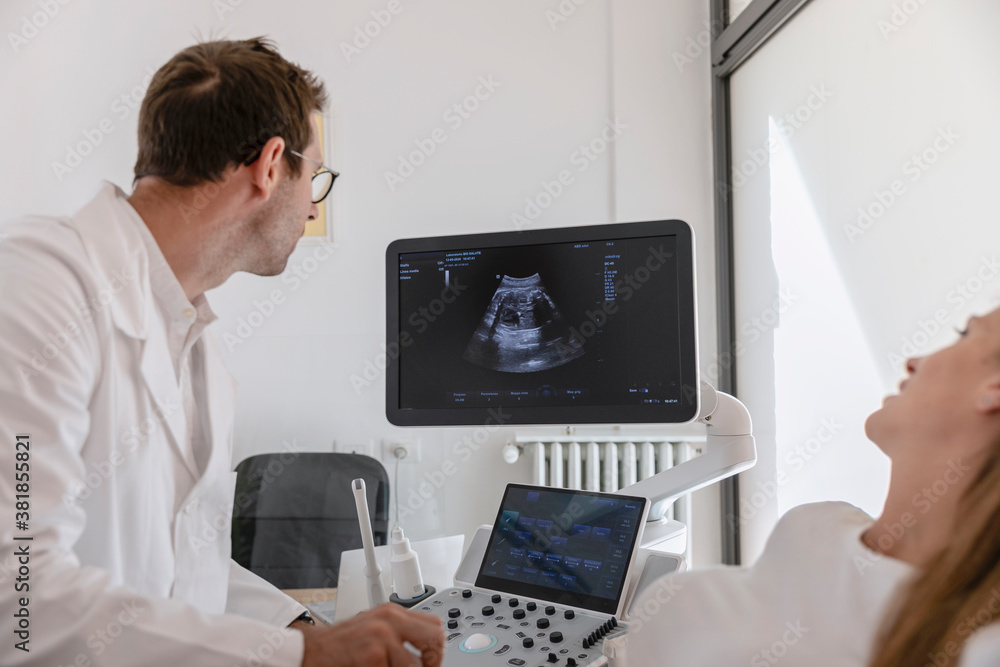 Doctor and patient looking at ultrasound image Doctor and patient looking at ultrasound image