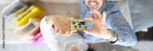 Man and woman are smiling and holding a bank card. Plastic cards for purchases concept