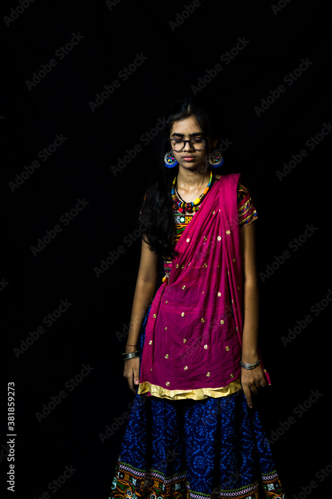 Indian girl in traditional chaniya choli for navratri with a fashionable  hairstyle poses in studio on black background. Navratri is an Indian  Festival and Chaniya choli its traditional costume Stock Photo |