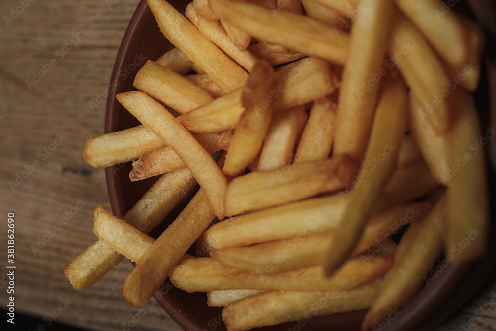 french fries on wooden background