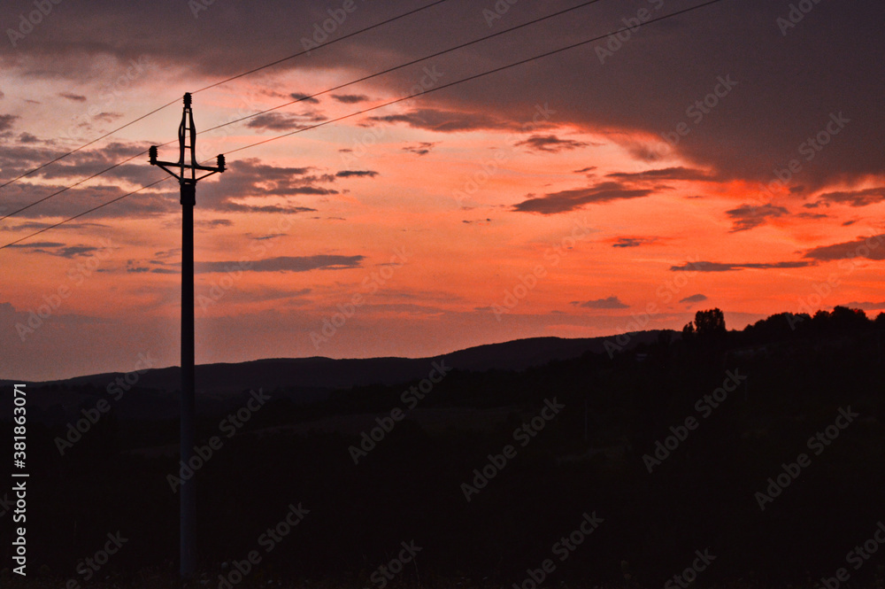 Sunset with a voltage pole