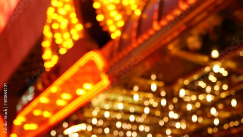 Defocused old fasioned electric lamps glowing at night. Abstract close up of blurred retro casino decoration shimmering, Las Vegas USA. Illuminated vintage style bulbs glittering on Freemont street. photo