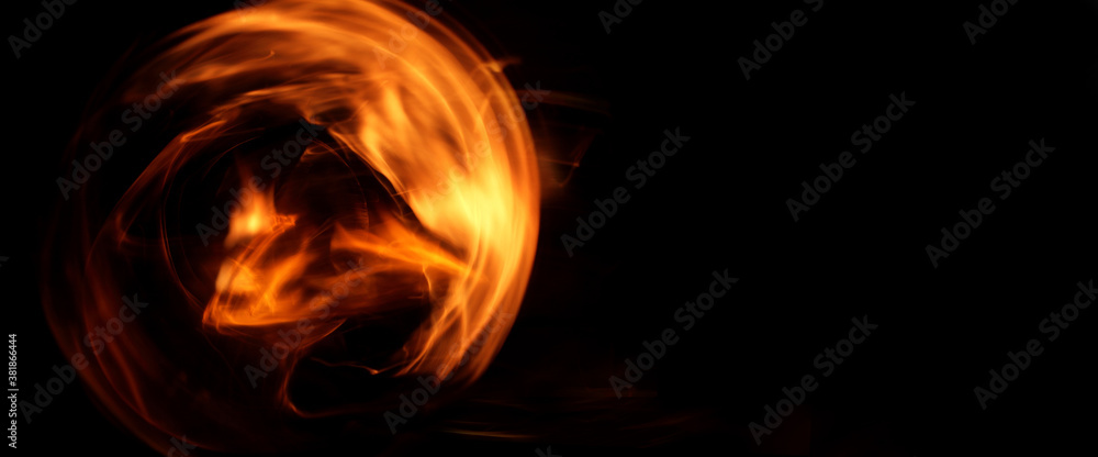 Fototapeta premium abstract fiery whirlwind on a dark background. flying fireball