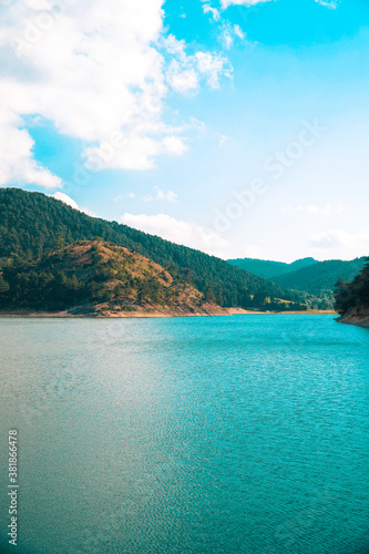 Vertical view of Sunnet Lake, clean water and blue sky, Mountain Forests at the far end, Bolu, Turkey