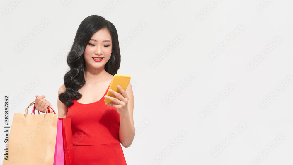 Portrait Asian beautiful happy young woman smiling cheerful and holding credit card and using smart phone for shopping online with shopping bags Portrait Asian beautiful happy young woman smiling cheerful and holding credit card and using smart phone for shopping online with shopping bags