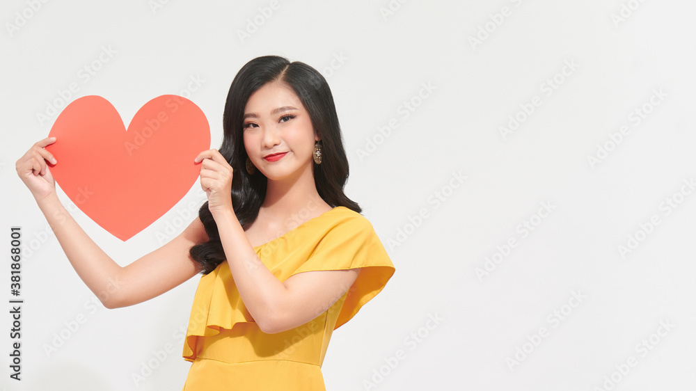 Portrait of happy romantic young girl with red paper heart-shaped postcard, romantic wishes, Valentine day celebration, love concept Portrait of happy romantic young girl with red paper heart-shaped postcard, romantic wishes, Valentine day celebration, love concept