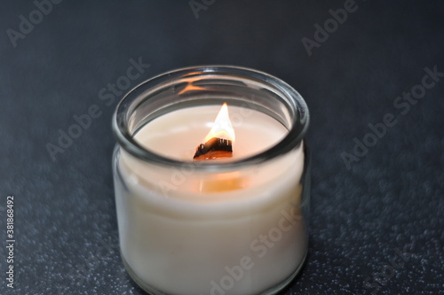 burning candles with wooden wick