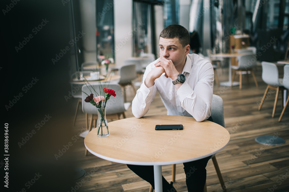 Thoughtful businessman looking away pensively