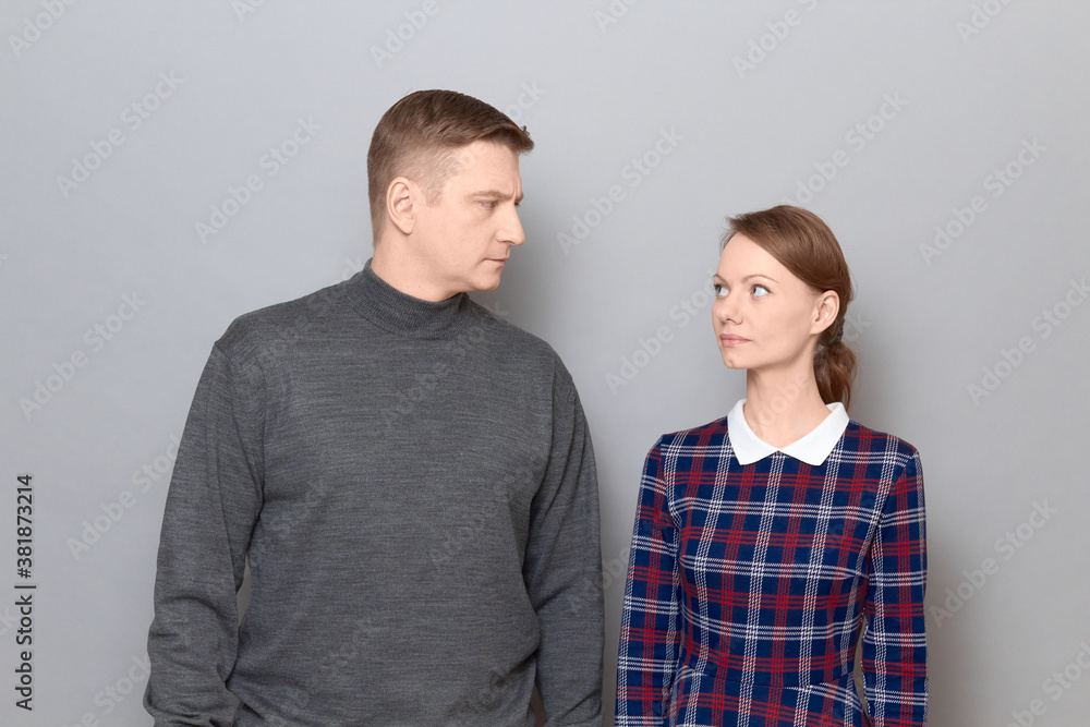 Portrait of serious man and woman looking attentively at each other Portrait of serious man and woman looking attentively at each other