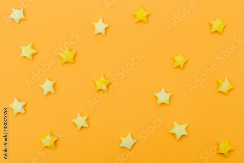 Solid yellow background with paper stars in a children's style. Template for scrapbooking.