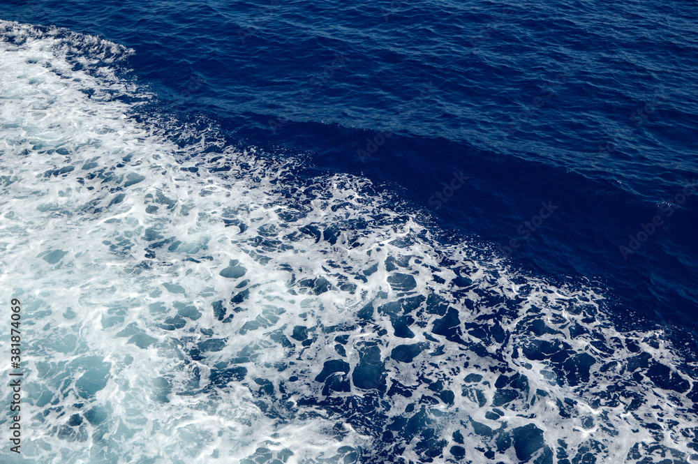 blue sea surface with white foam