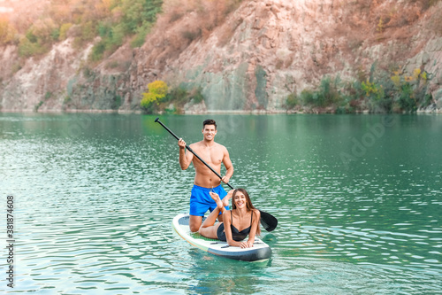 Young couple using paddle b...