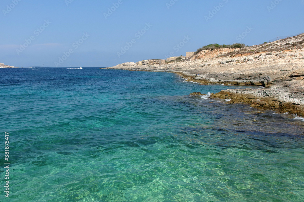 Fototapeta premium calm cyan sea with dry coast on Comino island, Malta