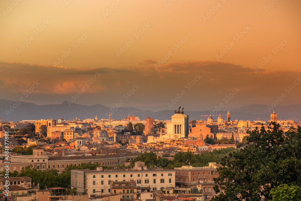 Beautiful skyline view of Roma from the Gianicolo hill at the sunset. Panorama of Rome from the above Colorful sky with orange clouds over the ancient monuments of the Italian Capital. Europe postcard