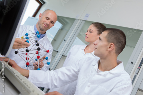 teacher and studenst working in a lab photo