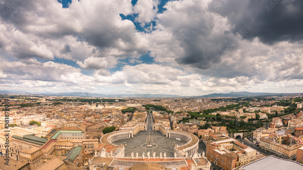 Panoramic view of Rome and vatican city from the San Pietro dome. Beautiful aerial panorama of the italian capital in a sunny day with clouds. Stunning city view from above with St. Peter's Square