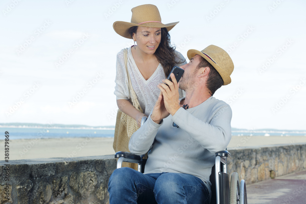 cheerful couple in wheelchairs outdoors