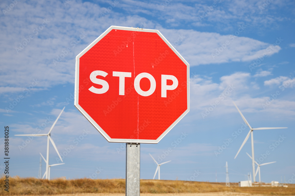 Obraz premium Stop signal and windmills