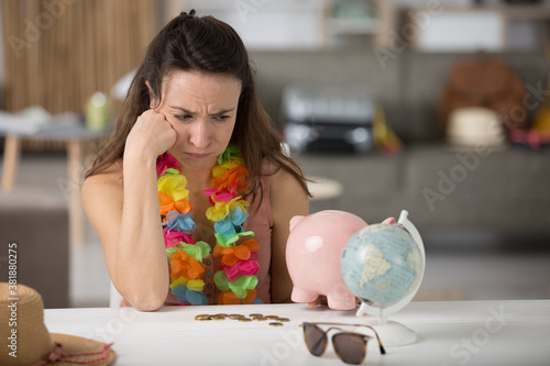 woman with piggy bank and world photo