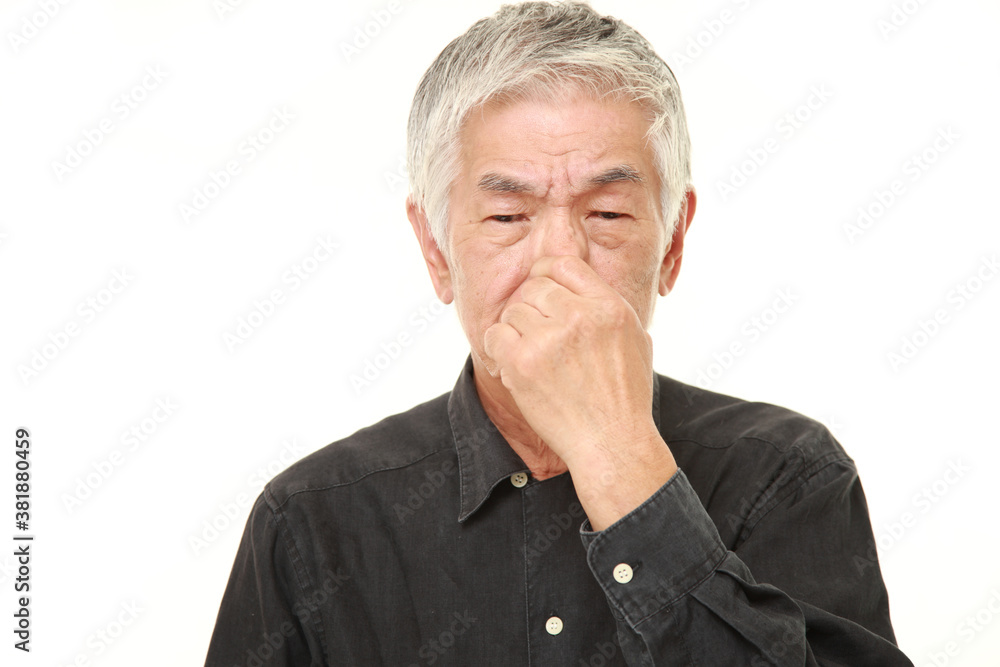 senior Japanese man holding his nose because of a bad smell
senior Japanese man holding his nose because of a bad smell