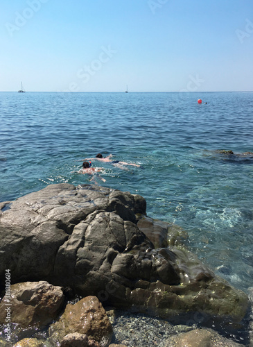 Crimea, Massandra / August, 2018: two children are engaged in scuba diving in the sea