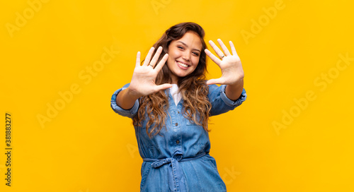 Принти на полотні smiling and looking friendly, showing number ten or tenth with hand forward, co