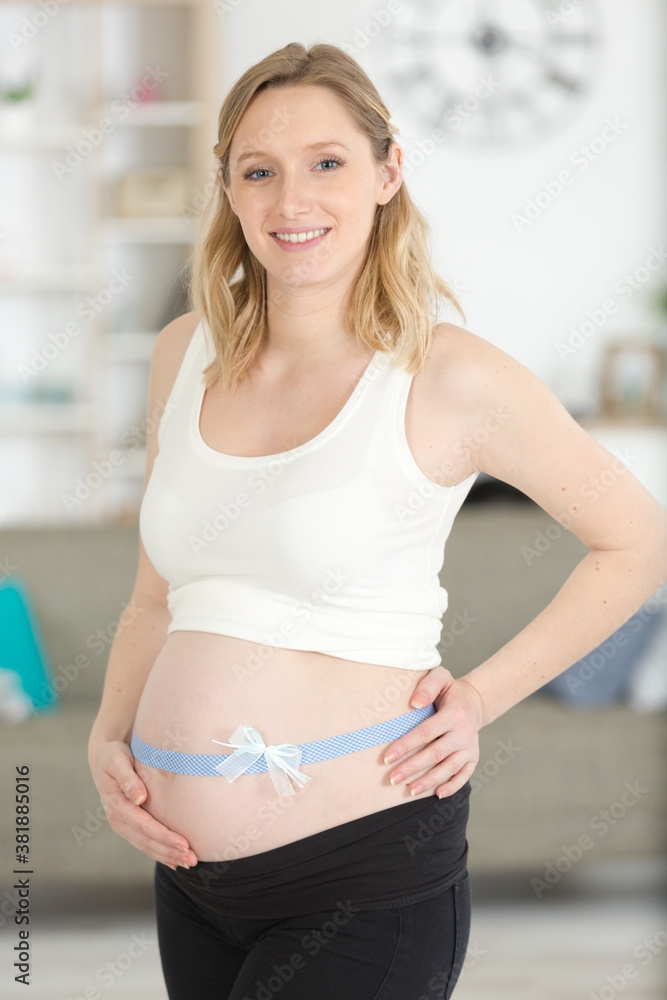 pregnant woman with a bow around her belly