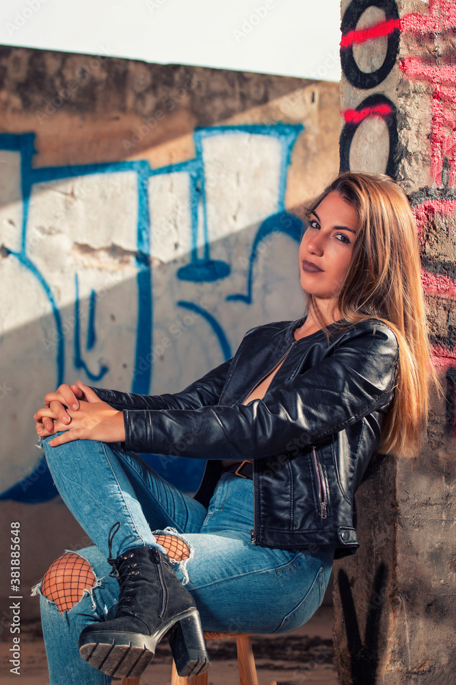 Model with leather jacket and blue jeans