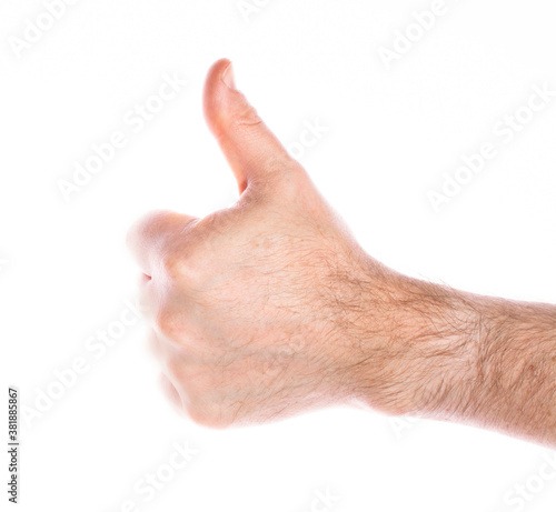 close-up of a man's hand with a raised thumb up on a white background, the concept of positive decision making, victory, approval.