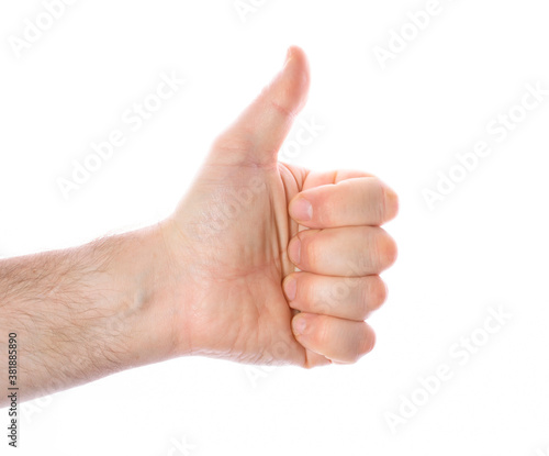 close-up of a man's hand with a raised thumb up on a white background, the concept of positive decision making, victory, approval.