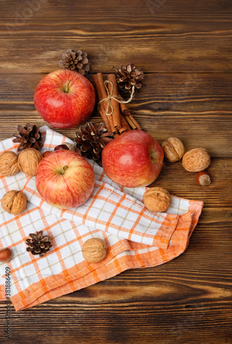 apples, cones, nuts, cinnamon on wooden table. autumn composition. fall time, thanksgiving, harvest concept. copy space