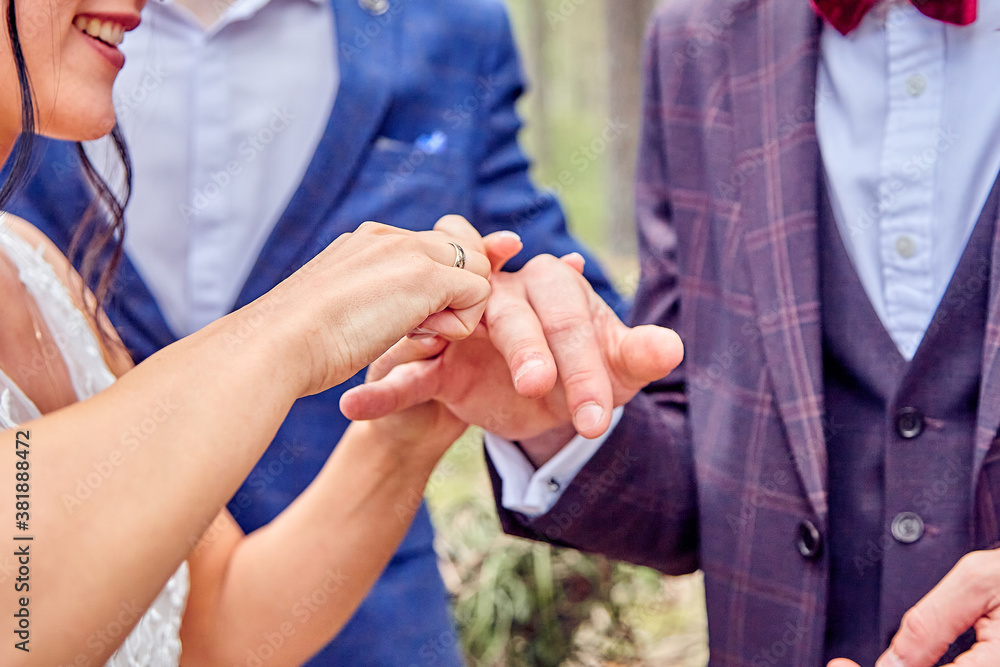 the bride puts the ring on the groom's finger the bride puts the ring on the groom's finger