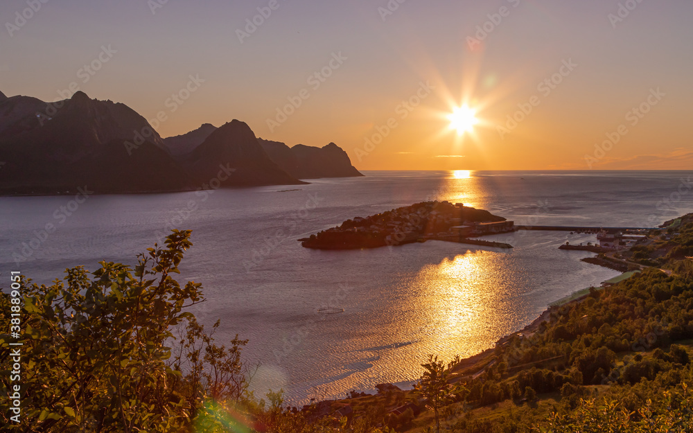 Sunset over the fishing village Husoy in Troms county. Island of Senja, Norway. Sunset over the fishing village Husoy in Troms county. Island of Senja, Norway.