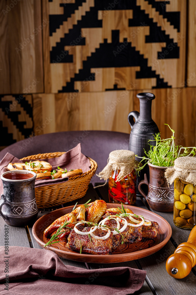 Turkish cuisine. Fried wings and lamb ribs are on the plate. Serving food in the restaurant. background image.