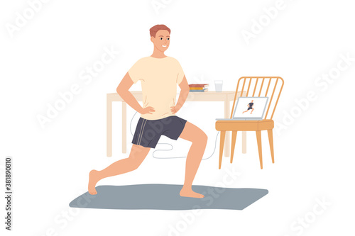 Man trains at home, does exercises from video tutorials