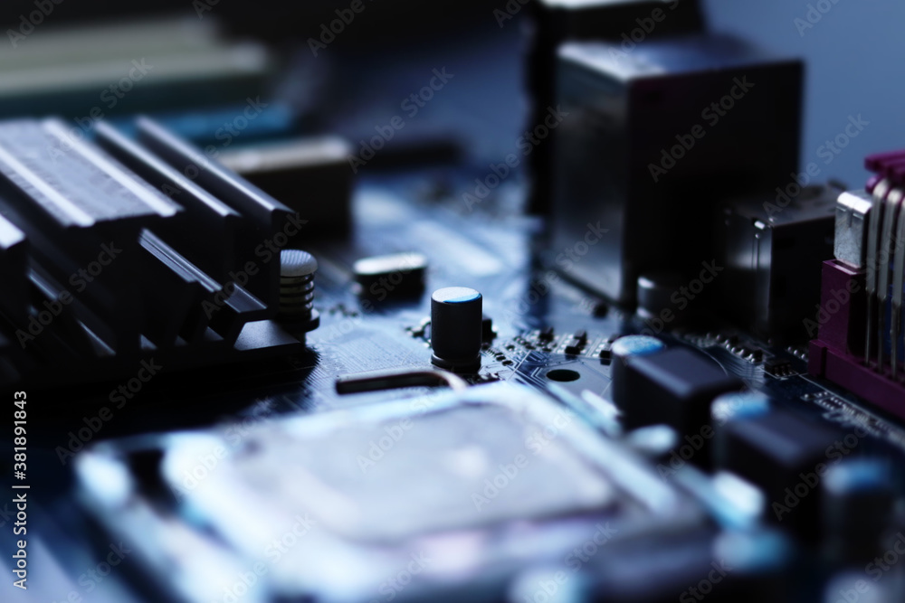 Blurred computer motherboard closeup in tilt shift style with selective focus. Defocused computer parts background Blurred computer motherboard closeup in tilt shift style with selective focus. Defocused computer parts background