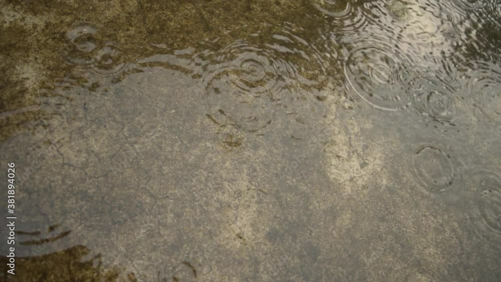 Monsoon Rain falling on the ground. Light Heavy Raindrops falling on concrete roof surface video footage. Rain fall sound effect. Sound of rain. Rainy season, nature background. Close up. Monsoon Rain falling on the ground. Light Heavy Raindrops falling on concrete roof surface video footage. Rain fall sound effect. Sound of rain. Rainy season, nature background. Close up.