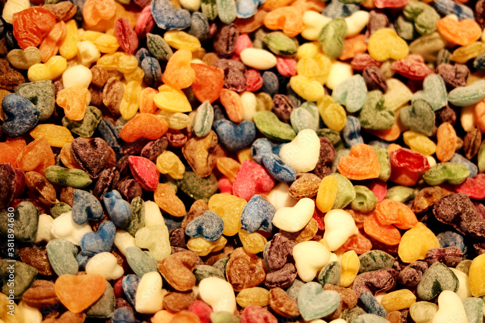 Multicolored candies in heart shape - close up