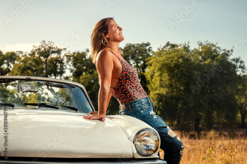 Woman with white convertible vintage car