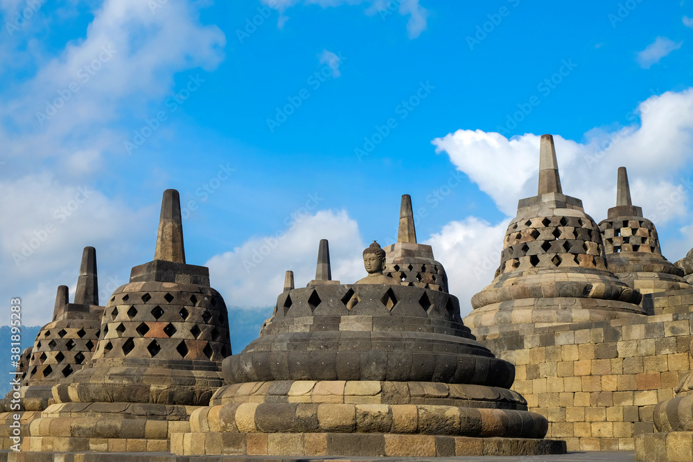 Stupas and Statue of Buddha at Borobudur Temple Stupas and Statue of Buddha at Borobudur Temple